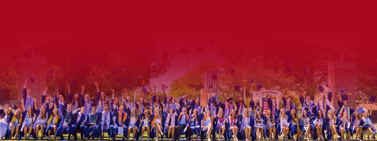 graduates throwing up their caps